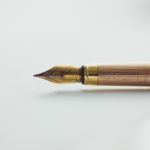 Brass fountain pen on white background. Image by Art Lasovsky.